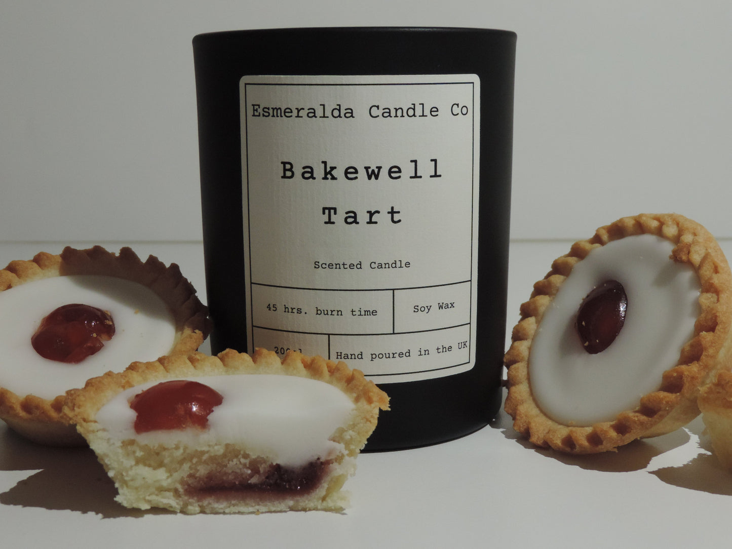 bakewell tart scented candle in matt black glass with 3 bakewll tart cakes