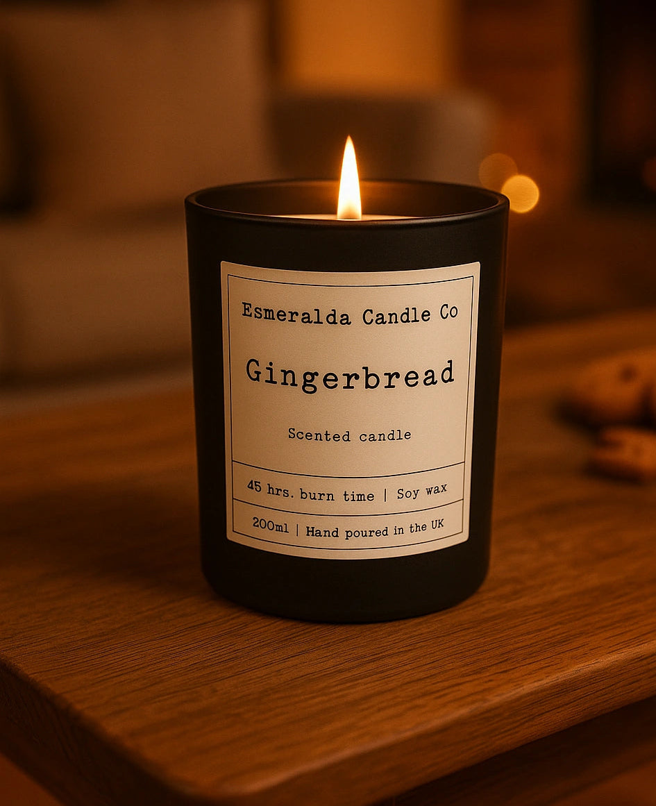 Gingerbread scented candle by Esmeralda Candle Co — hand-poured soy wax candle with 45-hour burn time, styled in a warm, cosy holiday setting with soft lighting.