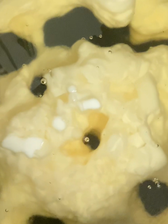Close-up of soy wax and fragrance oils beginning to melt and blend during the candle-making process at Esmeralda Candle Co.
