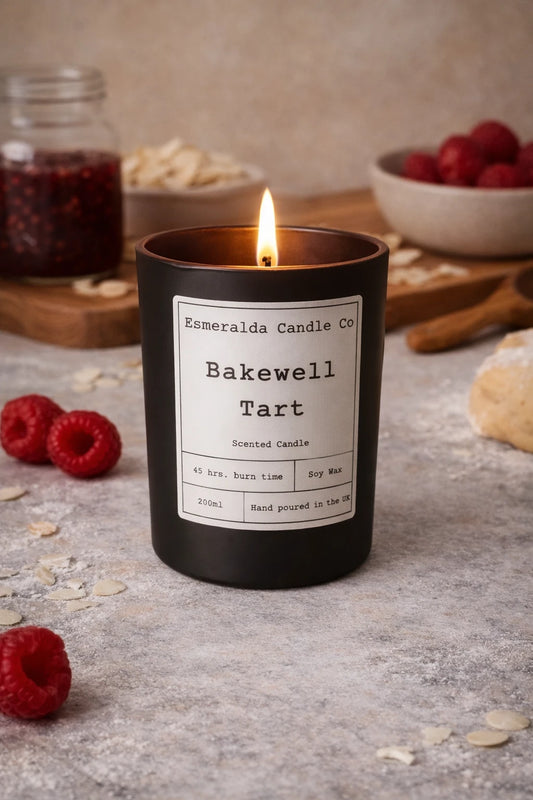 Bakewell Tart candle from Esmeralda Candle Co with raspberries and baking ingredients in the background.