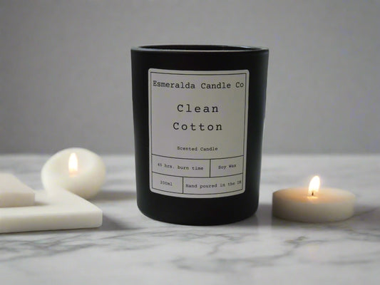 clean cotton scented black candle with limes around