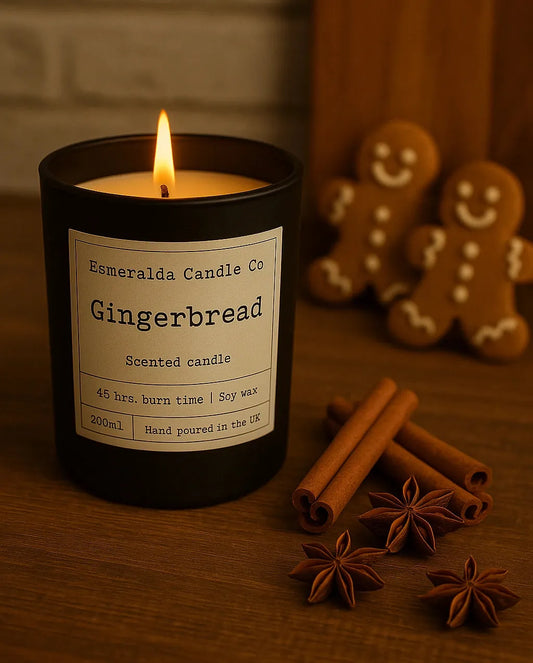 Gingerbread scented candle by Esmeralda Candle Co — hand-poured soy wax candle with 45-hour burn time, styled with cinnamon sticks, star anise, and gingerbread cookies for a festive holiday feel.