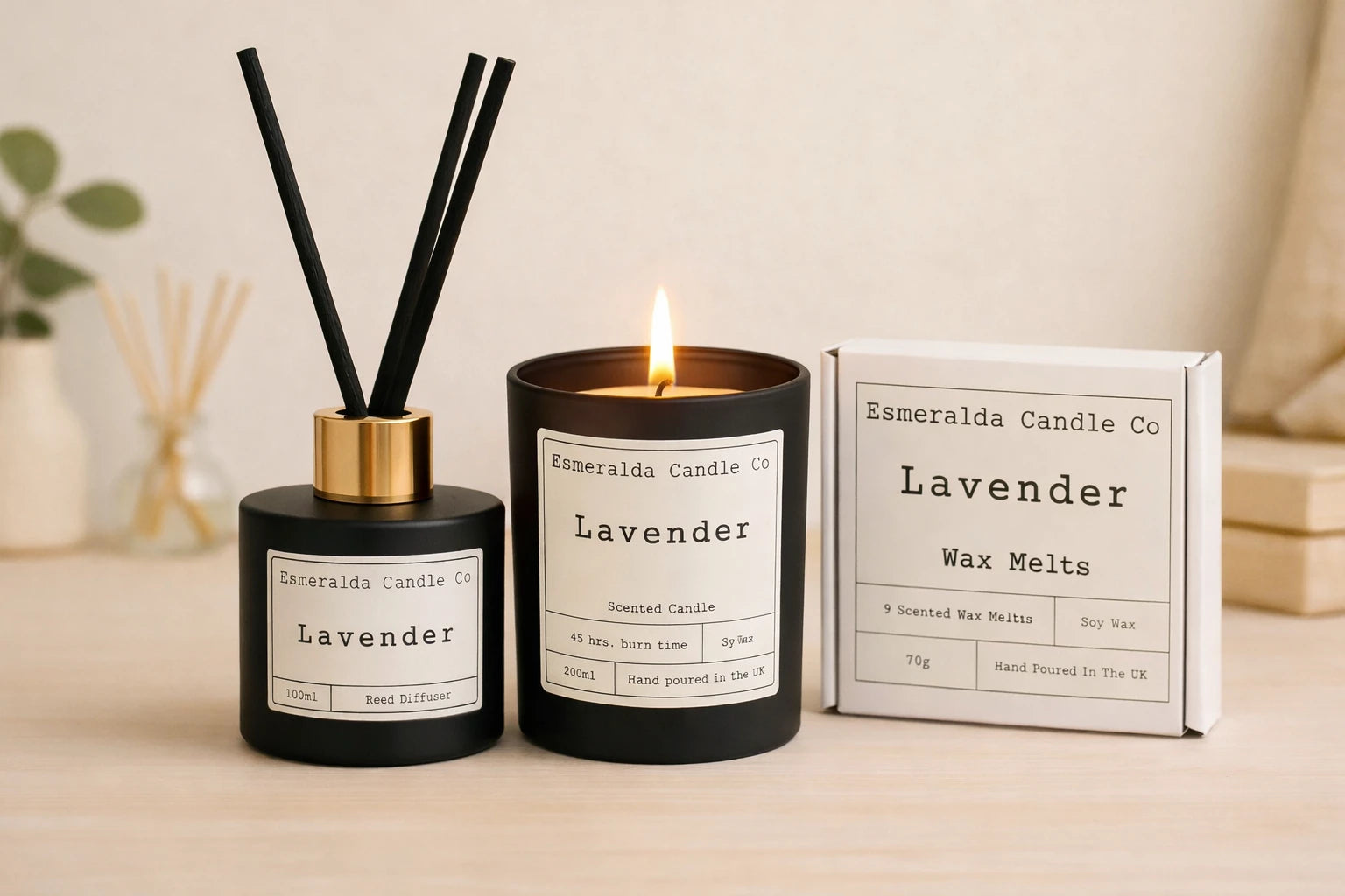 Lavender home fragrance collection by Esmeralda Candle Co featuring a matte black reed diffuser with gold collar, a lit lavender scented candle, and a box of lavender wax melts, styled on a soft neutral background for a calm, spa-like aesthetic.