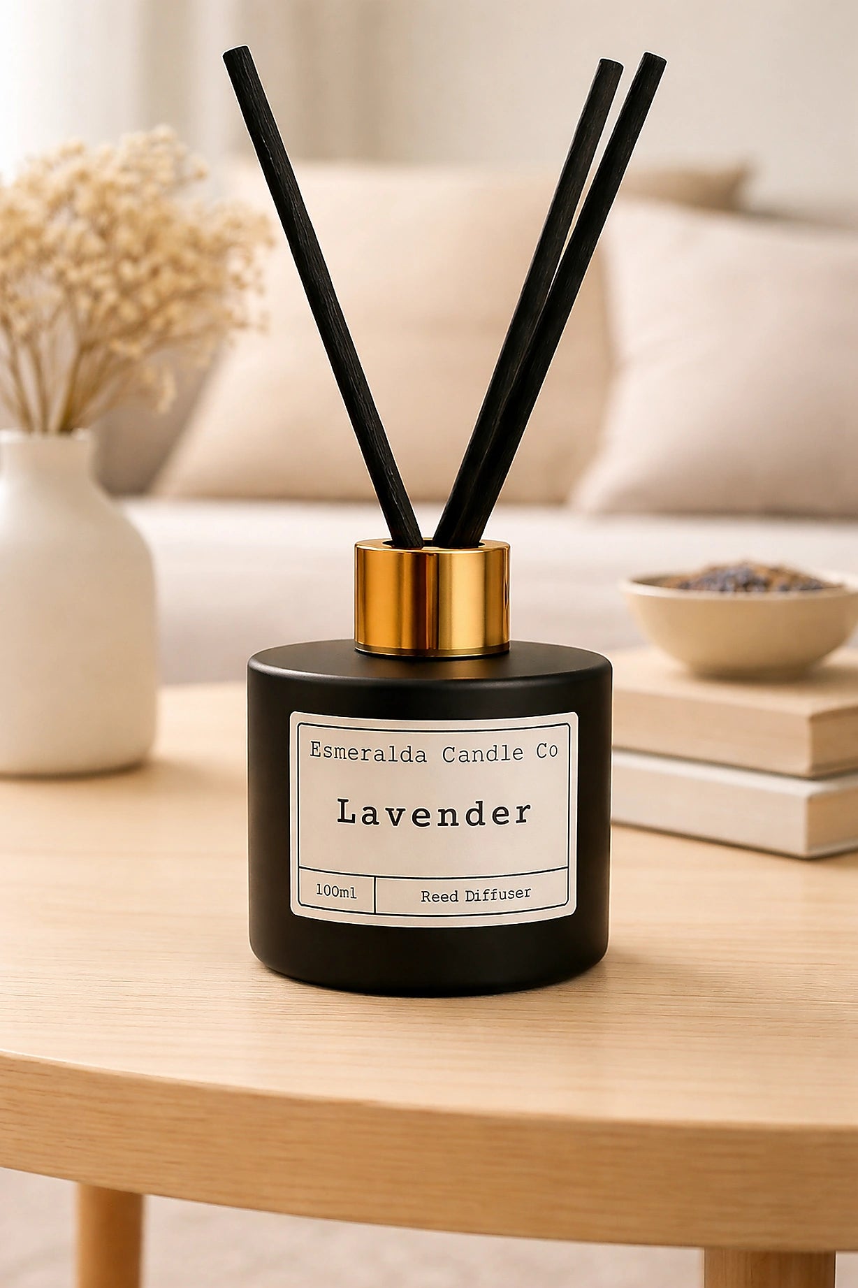 Lavender diffuser with black sticks on a wooden table in a home setting