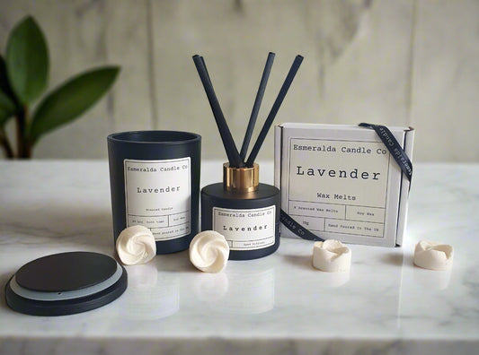 Lavender candle, diffuser, and melts on a surface with a tiled wall background