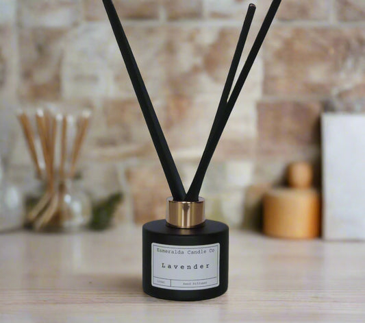 Lavender reed diffuser by Esmeralda Candle Co, 100ml black bottle with gold collar and black reeds, relaxing floral home fragrance.