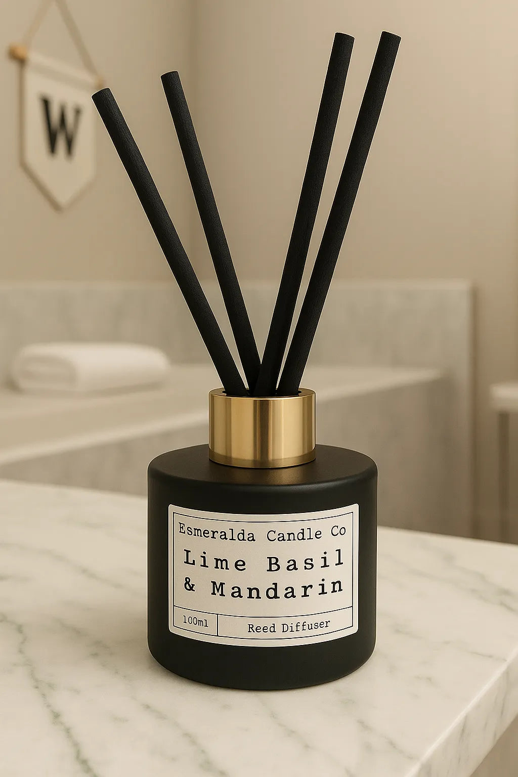 Esmeralda Candle Co Lime Basil & Mandarin reed diffuser on a marble bathroom countertop with gold collar and matte black bottle.